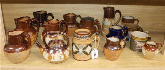 A collection of Doulton and other stoneware jugs and vessels